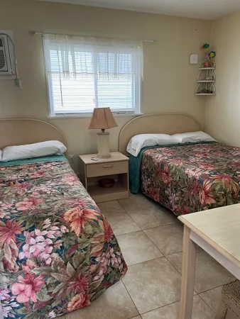 a bedroom with two beds and a window