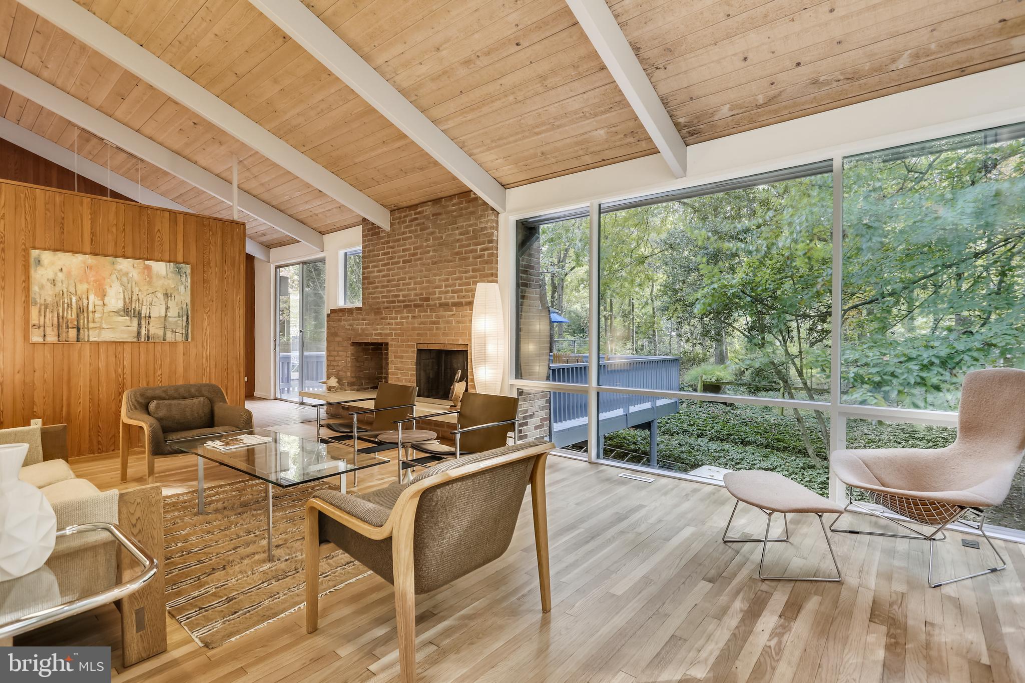 3928 Rickover Road Silver Spring, MD 20902 - Photo 11 of 62 a living room with patio furniture and a fireplace