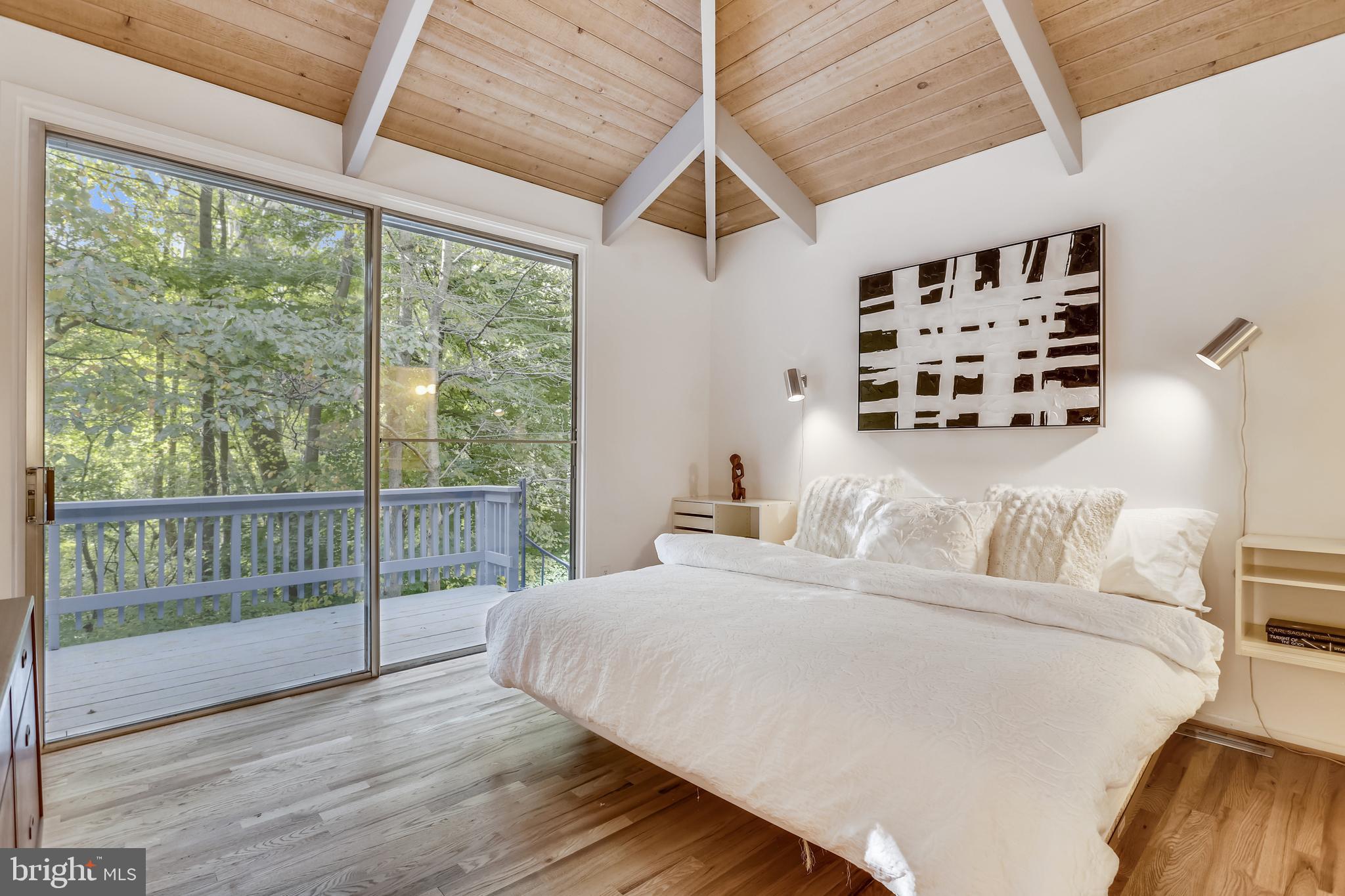 3928 Rickover Road Silver Spring, MD 20902 - Photo 19 of 62 a bedroom with a large bed and a large window with wooden floor
