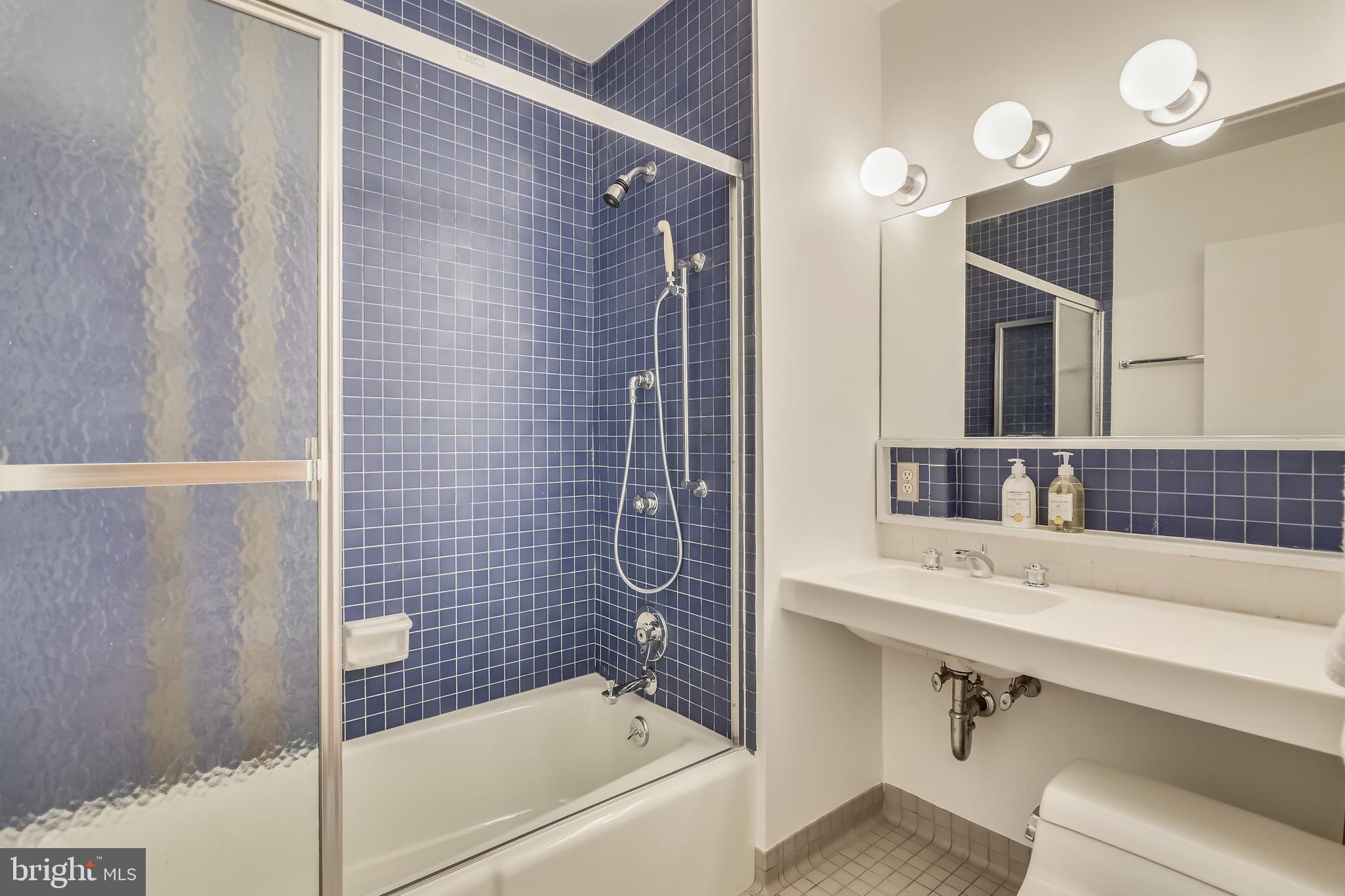 3928 Rickover Road Silver Spring, MD 20902 - Photo 33 of 62 a bathroom with a sink a mirror a bathtub and shower