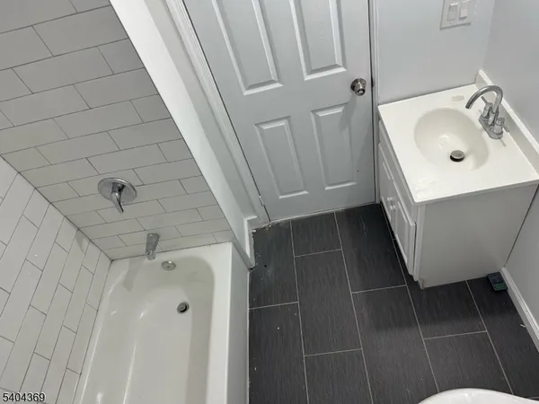 a bathroom with a sink a toilet a mirror and shower