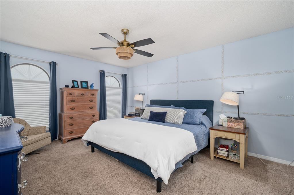 22 Rosedown Boulevard DeBary, FL 32713 - Photo 14 of 31 a bedroom with a bed and a chandelier