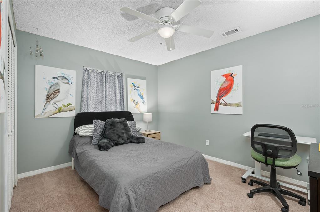 22 Rosedown Boulevard DeBary, FL 32713 - Photo 18 of 31 a bedroom with a bed and a chandelier