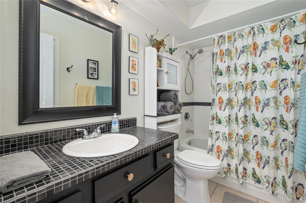 22 Rosedown Boulevard DeBary, FL 32713 - Photo 19 of 31 a bathroom with a granite countertop sink and a mirror