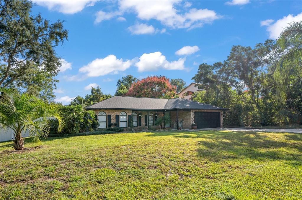 22 Rosedown Boulevard DeBary, FL 32713 - Photo 29 of 31 a view of a house with swimming pool and a yard