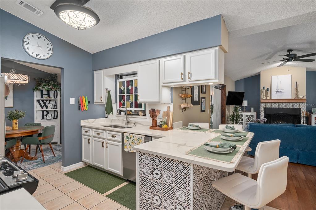 22 Rosedown Boulevard DeBary, FL 32713 - Photo 5 of 31 a kitchen with a stove a table and chairs in it
