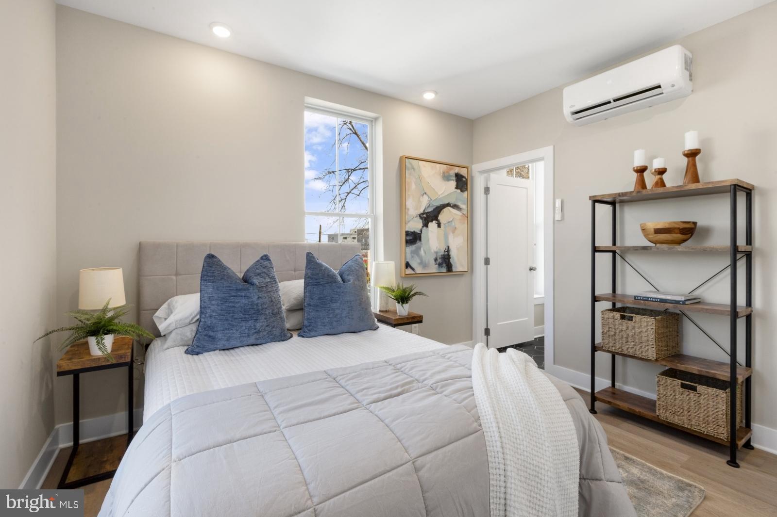 6712 Ridge Avenue, Unit 302 Philadelphia, PA 19128 - Photo 15 of 22 a large bed sitting in a bedroom next to a window