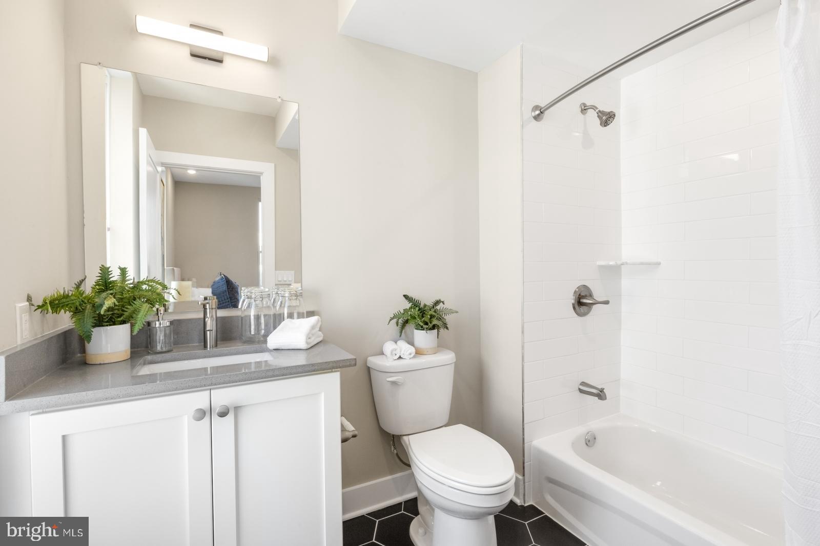 6712 Ridge Avenue, Unit 302 Philadelphia, PA 19128 - Photo 18 of 22 a bathroom with a sink toilet and shower