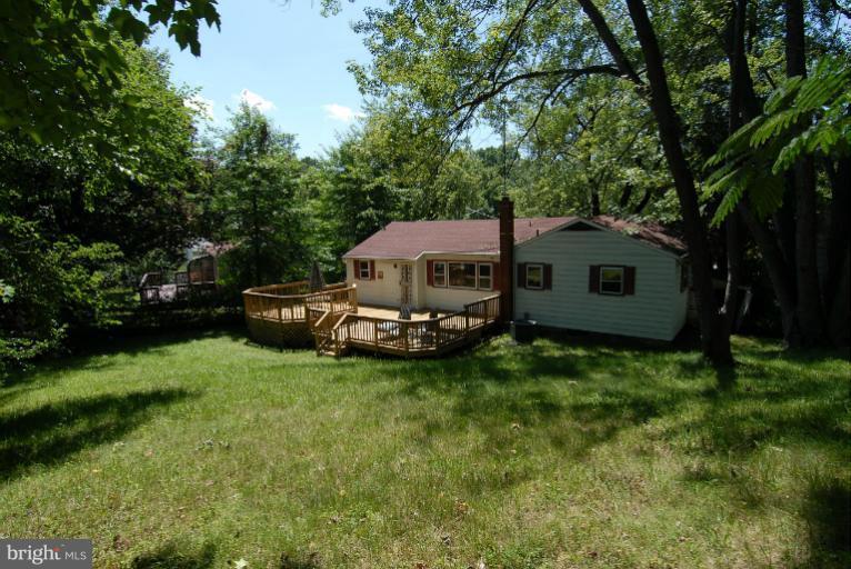 12003 Lafayette Court Silver Spring, MD 20902 - Photo 2 of 22 a view of a house with a big yard and large trees