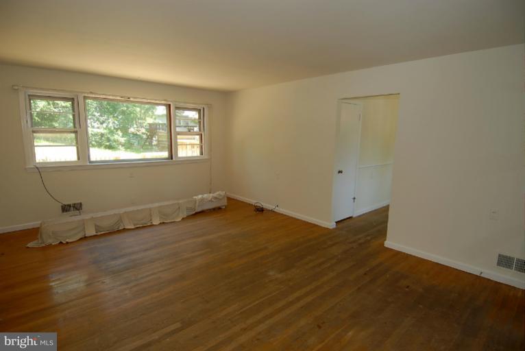 12003 Lafayette Court Silver Spring, MD 20902 - Photo 11 of 22 an empty room with wooden floor and windows