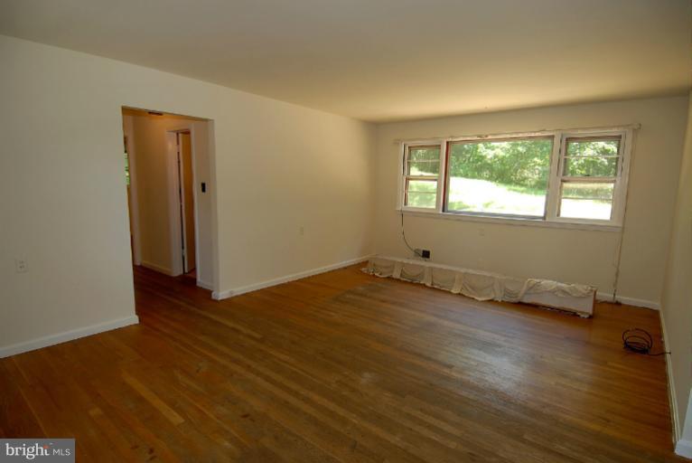 12003 Lafayette Court Silver Spring, MD 20902 - Photo 12 of 22 a view of an empty room with wooden floor and a window
