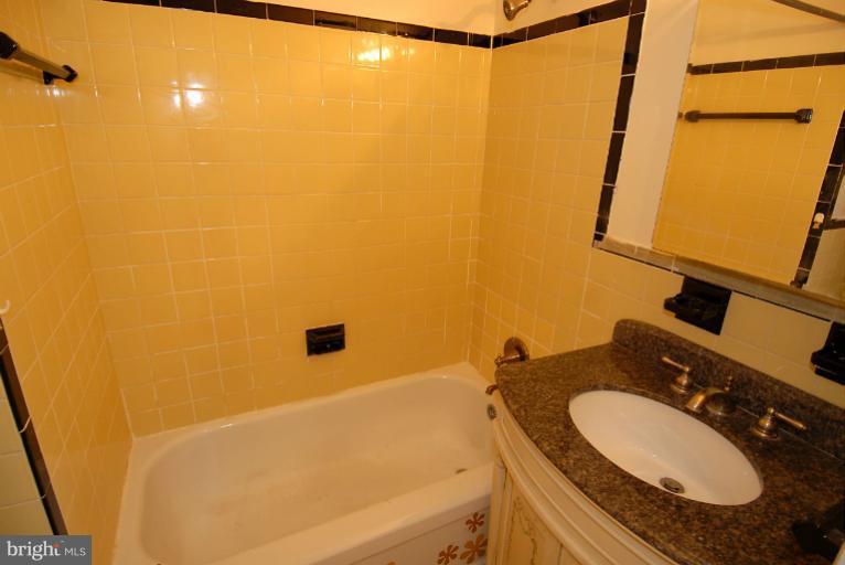 12003 Lafayette Court Silver Spring, MD 20902 - Photo 13 of 22 a bathroom with a granite countertop sink and a mirror