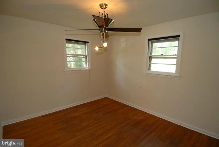 12003 Lafayette Court Silver Spring, MD 20902 - Photo 18 of 22 an empty room with a window and a chandelier fan