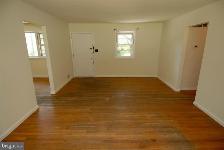 12003 Lafayette Court Silver Spring, MD 20902 - Photo 9 of 22 a view of an empty room with window and wooden floor