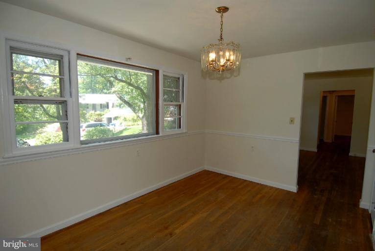 12003 Lafayette Court Silver Spring, MD 20902 - Photo 10 of 22 a view of empty room with wooden floor and fan