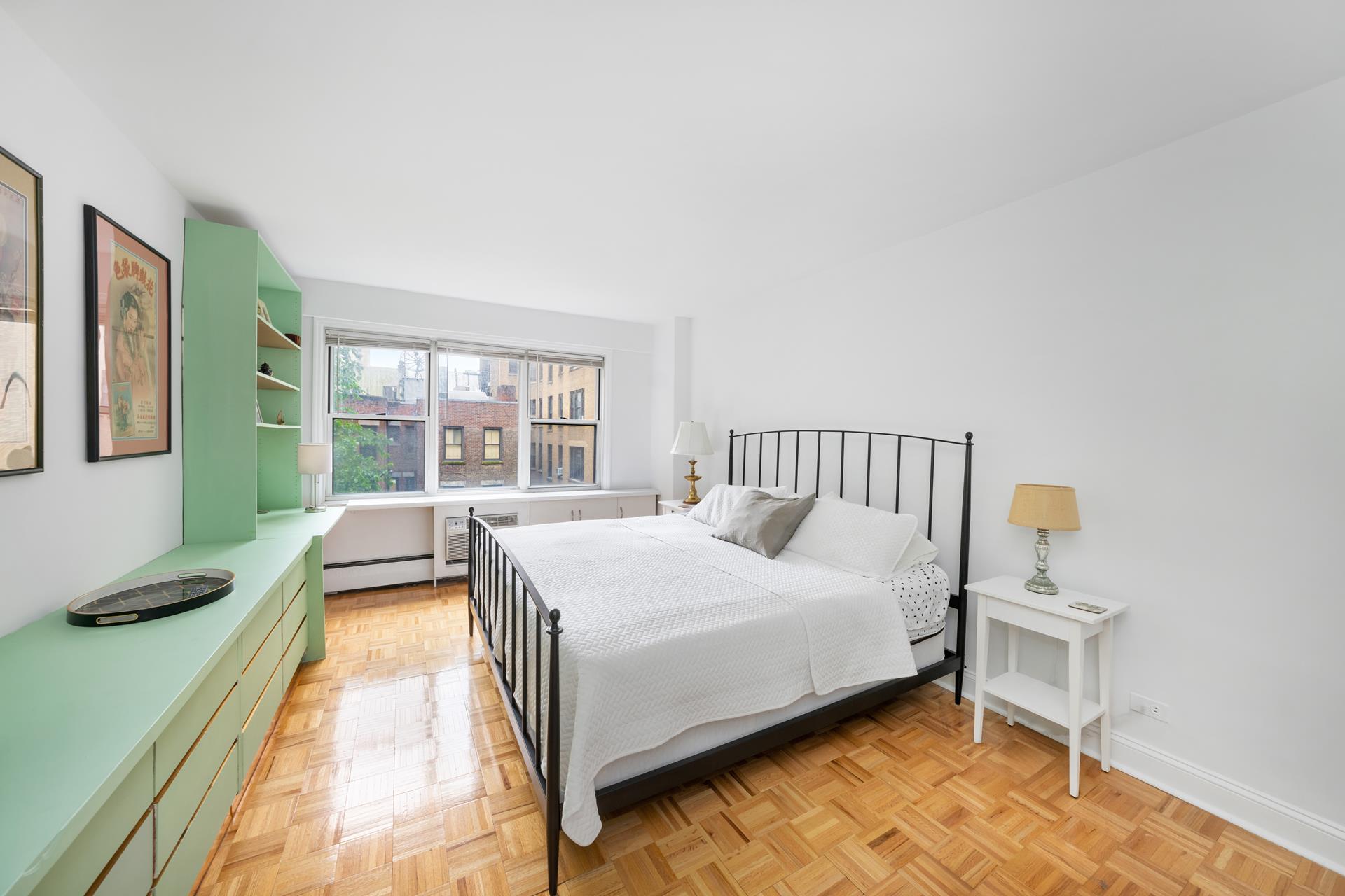 308 West 103rd Street, Unit 5C Manhattan, NY 10025 - Photo 3 of 7 a bedroom with a bed and a large window