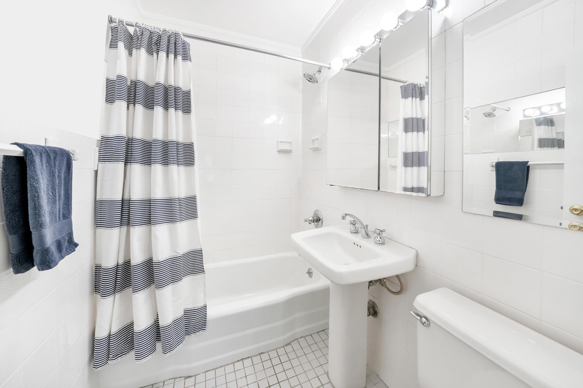 308 West 103rd Street, Unit 5C Manhattan, NY 10025 - Photo 4 of 7 a bathroom with a sink and a mirror