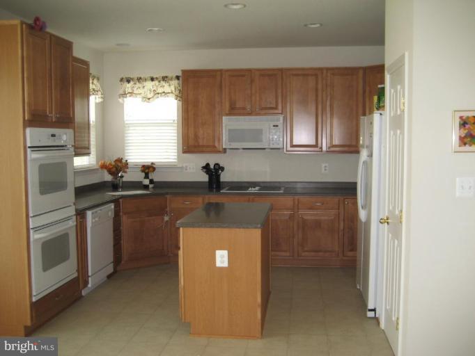 2010 Myrtlewood Road Baltimore, MD 21209 - Photo 2 of 11 a kitchen with granite countertop a sink stove and refrigerator