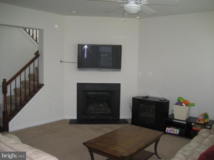 2010 Myrtlewood Road Baltimore, MD 21209 - Photo 5 of 11 a living room with furniture a flat screen tv and a fireplace