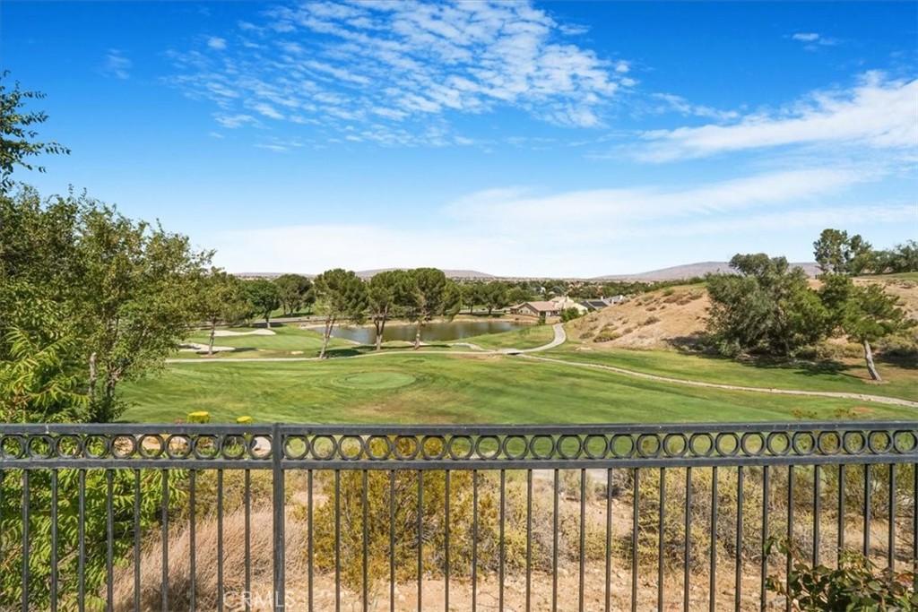 13097 Sage Hen Road Victorville, CA 92395 - Photo 20 of 63 a view of a green yard with a lake view