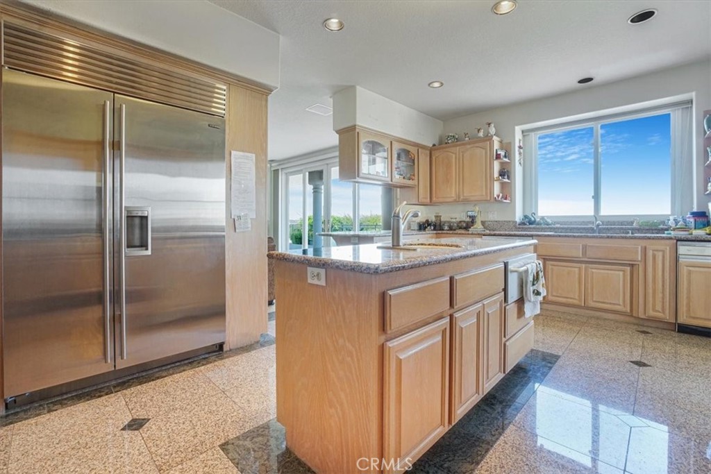 13097 Sage Hen Road Victorville, CA 92395 - Photo 38 of 63 a kitchen with stainless steel appliances granite countertop a refrigerator a sink and white cabinets