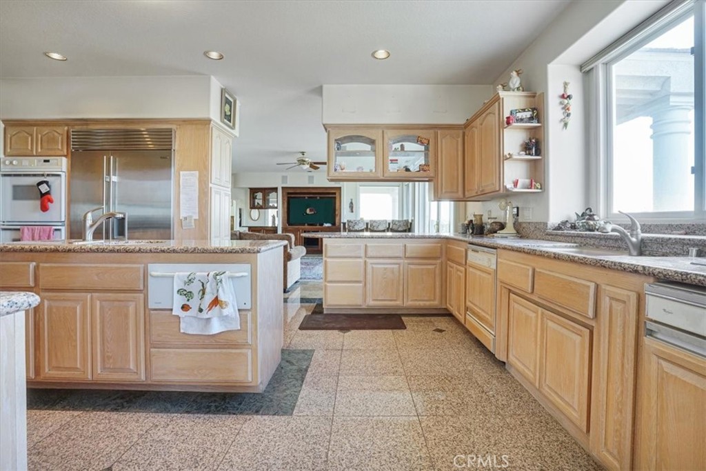 13097 Sage Hen Road Victorville, CA 92395 - Photo 41 of 63 a kitchen with cabinets a sink and appliances