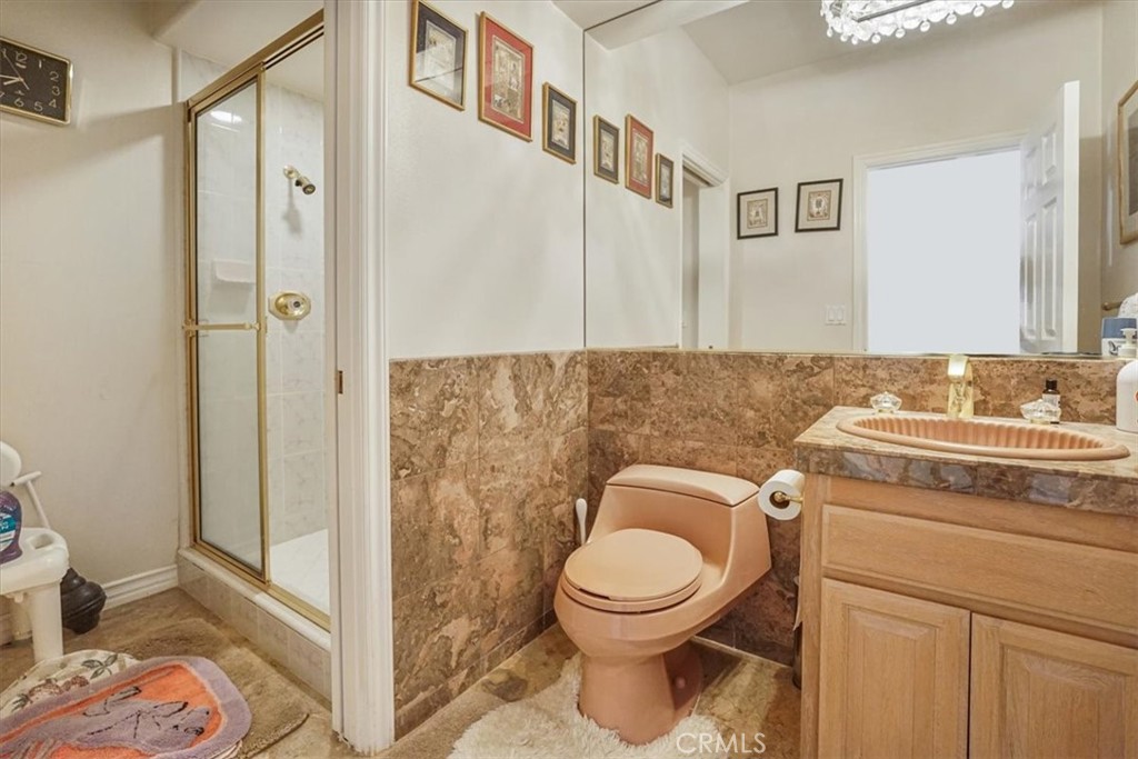 13097 Sage Hen Road Victorville, CA 92395 - Photo 44 of 63 a bathroom with a granite countertop sink toilet and shower