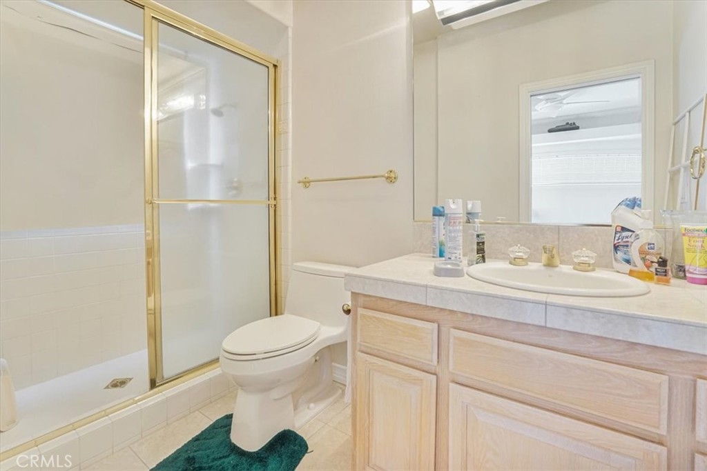 13097 Sage Hen Road Victorville, CA 92395 - Photo 46 of 63 a bathroom with a granite countertop sink a toilet and a shower