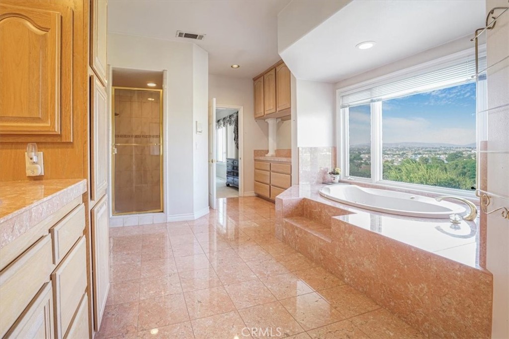13097 Sage Hen Road Victorville, CA 92395 - Photo 63 of 63 a spacious bathroom with a tub sink and mirror