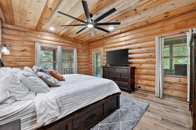 a bedroom with a large bed and a large window