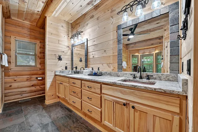 a bathroom with double vanity sink and a mirror