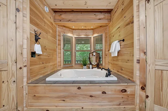 a bed room with a bed and a flat tv screen