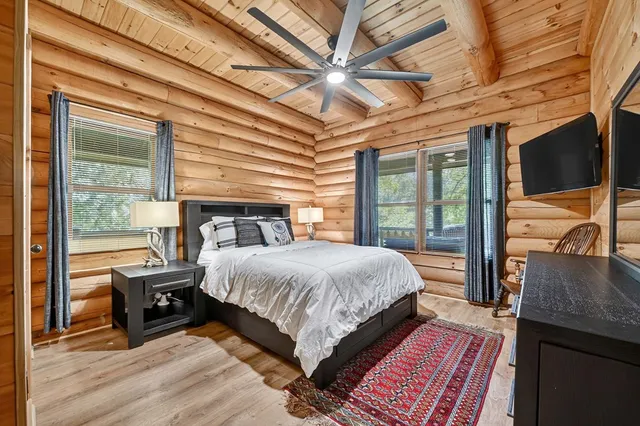 a living room with lots of furniture and kitchen view