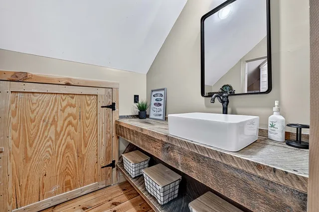 a view of a workspace with wooden floor and windows
