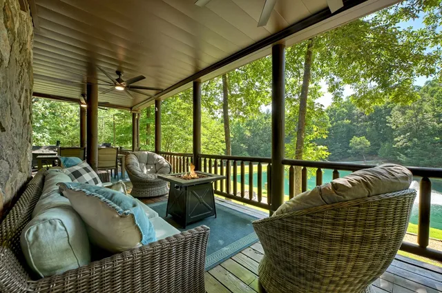 an aerial view of a house with a yard and trees all around
