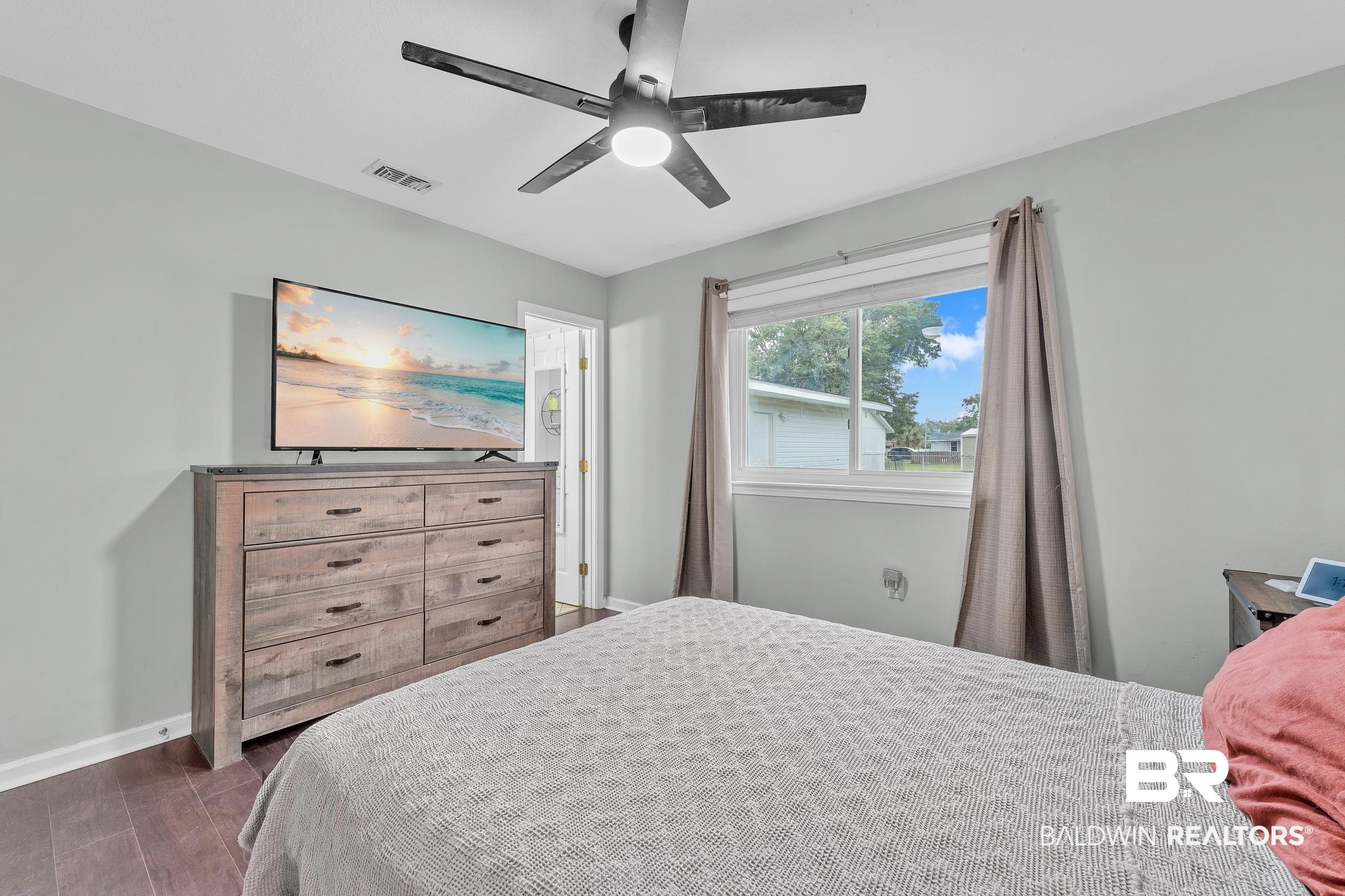 206 West Jackson Avenue Summerdale, AL 36580 - Photo 21 of 37 Bedroom with baseboards, dark wood-style flooring, and a ceiling fan