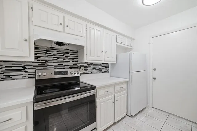 a kitchen with white cabinets and a sink