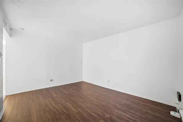 a view of a room with wooden floor