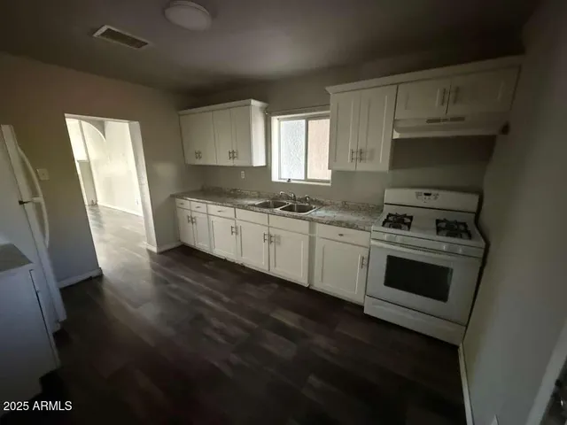 a kitchen with stainless steel appliances a stove a sink and a refrigerator
