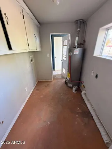 a view of a storage & utility room with windows