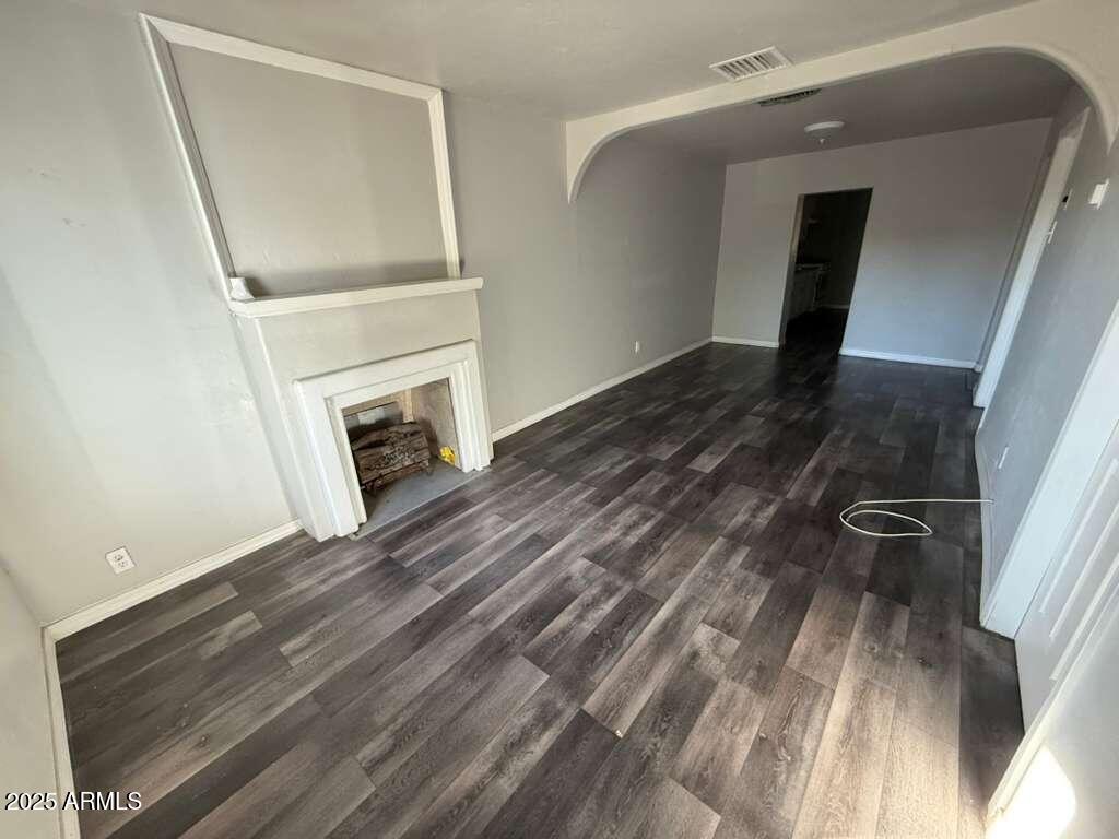 806 East 7th Street Douglas, AZ 85607 - Photo 2 of 18 a view of a livingroom with wooden floor and a fireplace