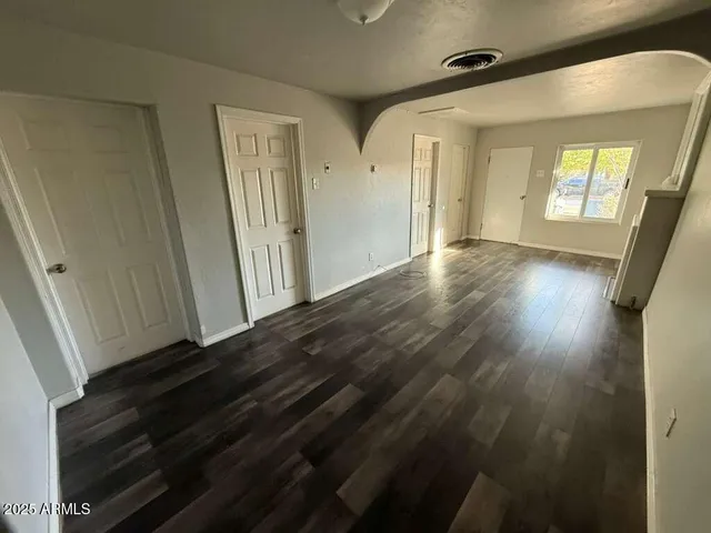 a view of an entryway with wooden floor