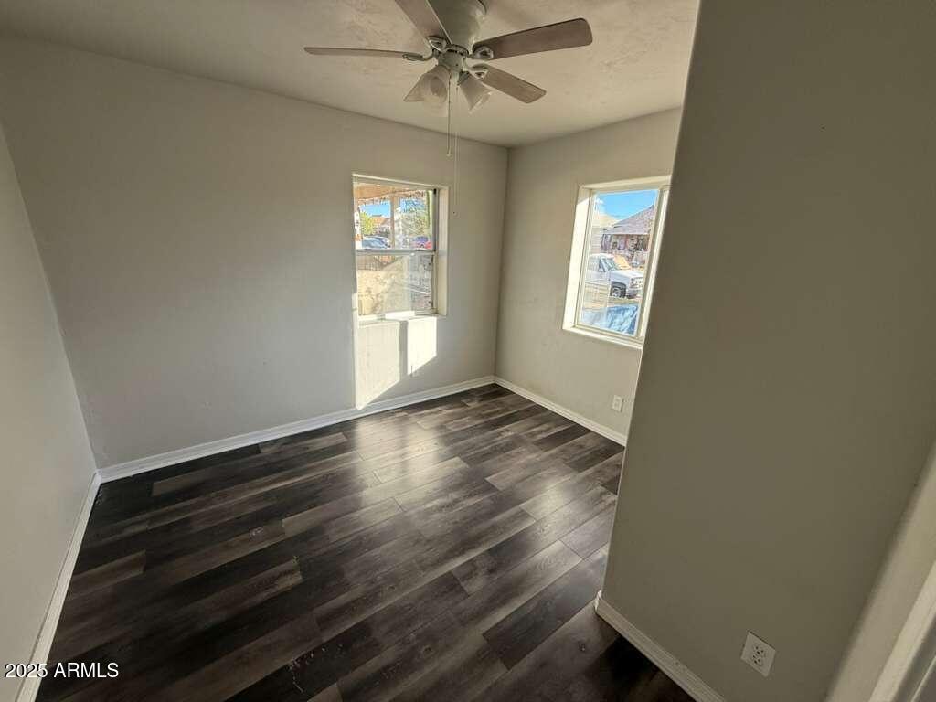 806 East 7th Street Douglas, AZ 85607 - Photo 4 of 18 a view of an empty room with wooden floor and a window
