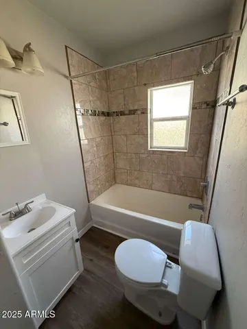 a bathroom with a sink mirror vanity and toilet