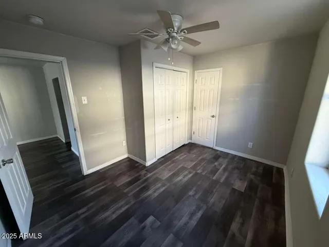 a view of an empty room and wooden floor