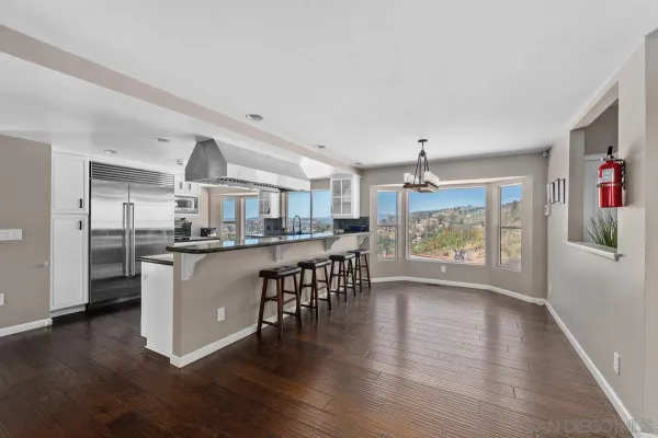 a kitchen with stainless steel appliances a stove and wooden floor