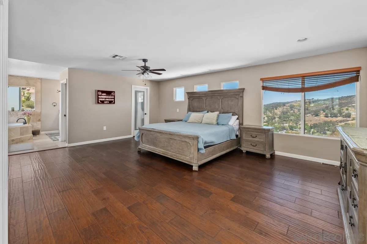 2155 Vista Valley Rim Place El Cajon, CA 92019 - Photo 21 of 61 a spacious bedroom with a bed and large window