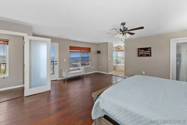 a bathroom with a tub and a large window