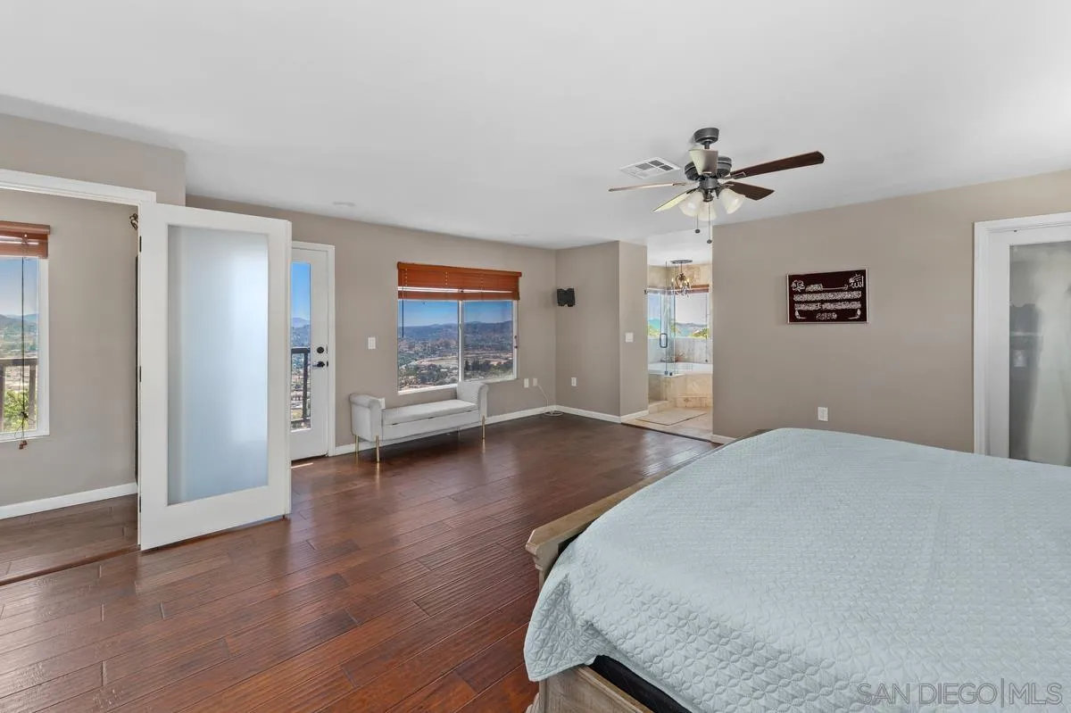 2155 Vista Valley Rim Place El Cajon, CA 92019 - Photo 22 of 61 a view of a livingroom with hardwood floor and a ceiling fan