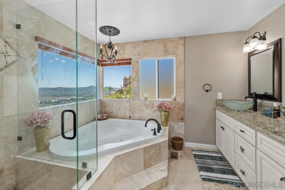 2155 Vista Valley Rim Place El Cajon, CA 92019 - Photo 23 of 61 a spacious bathroom with a granite countertop tub sink and mirror